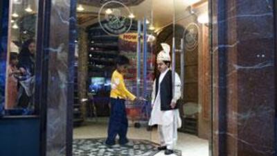 Alam Rehmen at work on the door of Al Ibrahimi. "Everybody is happy when they see me, all different nationalities," he says.