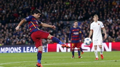 Barcelona’s Luis Suarez shoots and scores his side’s third goal against AS Roma on Tuesday night at the Camp Nou. Manu Fernandez / AP