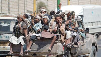 Armed Yemeni Shiite Houthi anti-government rebels travel in the back of a pickup truck on Sunday in the capital Sanaa. Mohammaed Huwais / AFP