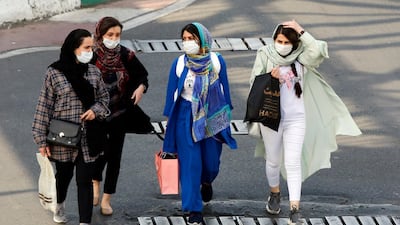 epa09143234 Iranian women wearing face masks walk on a street in Tehran, Iran, 18 April 2021. According to Iranian health ministry 405 people have died and more than 21.000 new infections were diagnosed from COVID-19 in past 24 hours as Iran is facing fourth wave of coronavirus pandemic. EPA/ABEDIN TAHERKENAREH