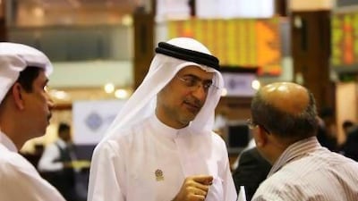 Mohammed Sharaf, the chief executive of DP World, chats with guests after his presentation at Dubai Financial Market. Pawan Singh / The National