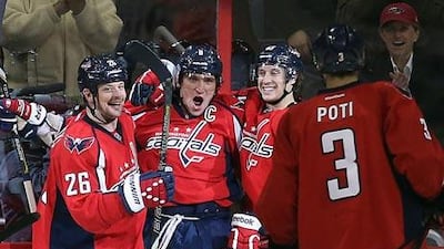 (Left to right) The Washington Capitals Matt Hendricks, Alex Ovechkin, Jay Beagle and Tom Poti celebrate a Ovechkin goal against the New Jersey Devil. Bruce Bennett / Getty Images / AFP
