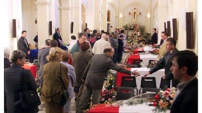 Mourners in Cherbourg, France pay their respects to the 11 French citizens killed in a bomb attack in 2002.