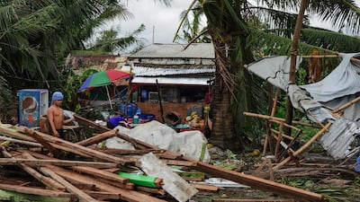 A resident looks at a house damaged at the height of Typhoon Phanfone in Tacloban, Leyte province in the central Philippines. AFP