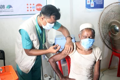 A Rohingya refugee receives a dose of a Covid-19 vaccine at their camps in Cox's Bazar, Bangladesh, this month. EPA