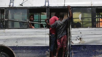 Passengers ride on a bus in downtown Port-au-Prince, Haiti. AP
