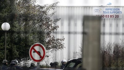 An assault group stand outside the building. Yoan Valat / EPA