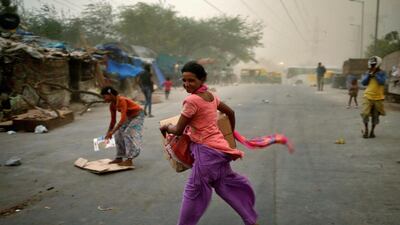 People are caught in a dust storm in New Delhi. Anindito Mukherjee / Reuters