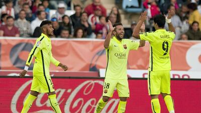 Barcelona defender Jordi Alba, centre, celebrates with Neymar, left, and Luis Suarez after scoring during the Spanish Primera Liga match against Almeria on November 8, 2014, at Juegos Mediterraneos stadium in Almeria. Jorge Guerrero / AFP