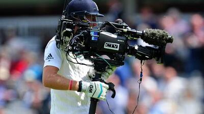 Joe Root uses a television camera after colliding with it’s operator. Dan Mullan / Getty Images / May 21, 2015