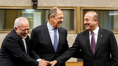 Iranian Foreign Minister Mohammad Javad Zarif, left, Russian Foreign Minister Sergei Lavrov, centre, and Turkish Foreign Minister Mevlut Cavusoglu, right, shake hands after consultations on Syria in Geneva. EPA