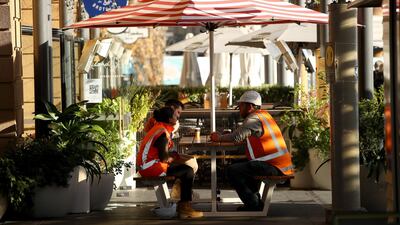 People enjoy a coffee outside at the Fullers Fery terminal in Auckland, New Zealand. Getty Images