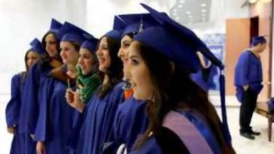 A group of students from the New York Institute of Technology gather before the start of their graduation ceremony on Wednesday at the Armed Forces Officers Club in Abu Dhabi.