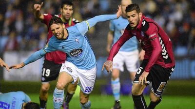 Celta Vigo defender Sergi Gomez, left, vies with Alaves defender Theo Hernandez during the first leg of their Copa del Rey semi-final at the Balaidos stadium in Vigo on February 2, 2017. Miguel Riopa / AFP
