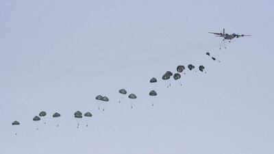 @Caption:An aircraft drops paratroopers during the Northern Thunder exercises. Abedullah Al Desori / Reuters
