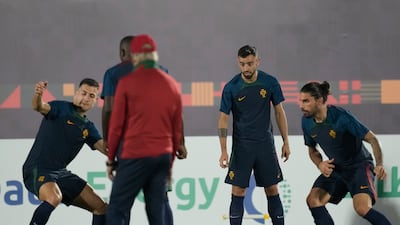 Portugal's Bruno Fernandes, second from right, warms up during training. AP