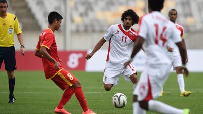 Vu Minh Tuan, second from left, of Vietnam chases Hassan Abdullah Waled Hussain, centre, of the UAE during their men’s round of 16 football match of the 2014 Incheon Asian Games, at Hwaesong Sports Complex some 50km from Incheon on September 26, 2014. UAE won 3-1. AFP PHOTO / Ed Jones