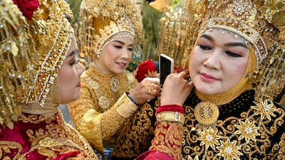 Women prepare to take part in a carnival parade, as part of a cultural event in Banda Aceh, Indonesia. AFP