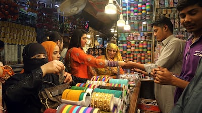 Women buy traditional bangles in preparation for the upcoming Eid Al Fitr celebrations, in Lahore, Pakistan. AP Photo