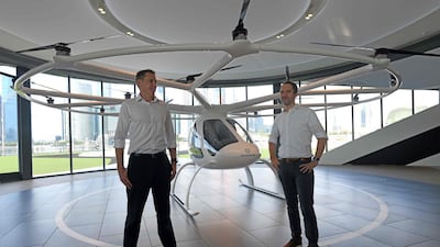 Florian Reuter (R), CEO of Volocopter and Duncan Walker (L), managing director of Skyports stands in front of the Volocopter unmanned air taxi transport during a press conference ahead of the 26th Intelligent Transport Systems World Congress (ITSWC) in Singapore. AFP