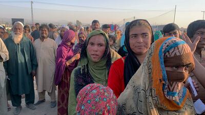 Afghan families gather to receive food on the outskirts of Chaman, a border town in Pakistan's southwestern Baluchistan province. Dozens of Afghan families have crossed into Pakistan. Photo: AP