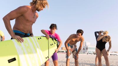 Antoine, 16-year-old student from Jumeirah College created a community-based surf club for teens with Down Syndrome two years ago. They meet every two weeks at Sunset beach for surf lessons. Verano Field (pink and blue) gets help with her board for the start of the surfing class. Antonie Robertson / The National