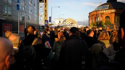 People wait outside the security gates to gain entrance to the venue on day three of the Cop26 summit. AP Photo