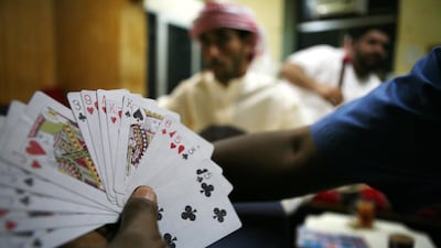 You'll always find a collective of noisy card players in Abu Dhabi's shisha cafes. Galen Clarke / The National