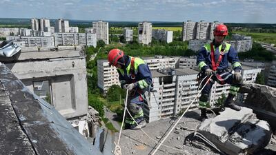 Rescuers dismantle collapsing structures of a heavily damaged 16-storey residential building in the Saltivka district of Kharkiv. AFP