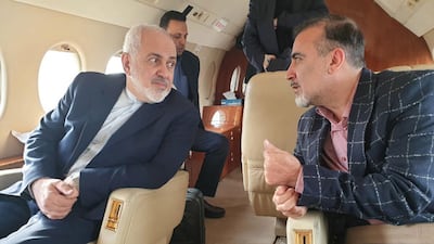 A handout photo made available by Iranian Foreign Affairs Minister Mohammad Javad Zarif's Twitter account on 7 December 2019 shows Zarif (L) and Iranian researcher Masoud Soleimani sitting inside an airplane at an undisclosed airport in Switzerland. EPA