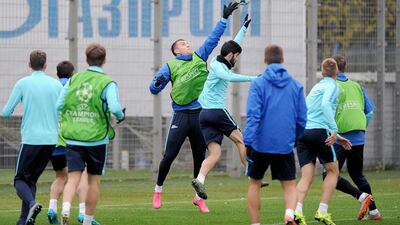 Center L-R: Zenit's Russian forward Artem Dzyuba and Zenit's Portuguese defender Luis Neto take part in a training session at Zenit's training ground in St. Petersburg on October 19, 2015 on the eve of the UEFA Champions League group H football match between FC Zenit and Olympique Lyonnais. AFP PHOTO / OLGA MALTSEVA