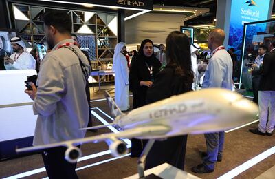 Visitors inspect the Etihad Airways stand during the Arabian Travel Market event in Dubai. Photo: EPA