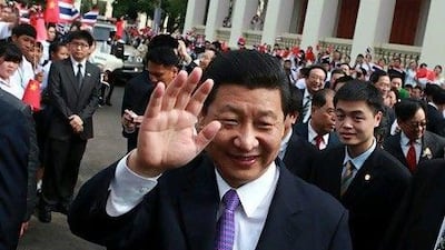 Chinese Vice President Xi Jinping waves to Thai students during a recent visit to Chulalongkorn University in Bangkok.