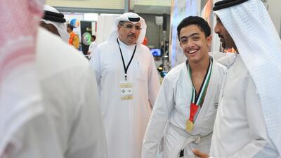 Ali Taha Alhashmi is congratulated by his father after he won first place and took the gold in the white belt junior 62k in the Al Ain Jiu-Jitsu Junior Open. Delores Johnson / The National / September 20, 2015