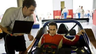 Humaid Al Masaood works with a technician to make sure his Radical SR-3 is ready to race at the Dubai Autodrome.