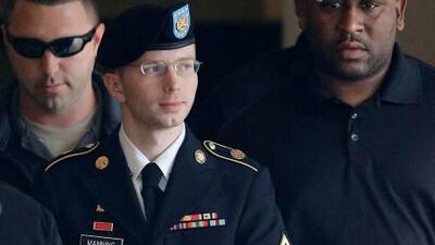 Bradley Manning is escorted to a security vehicle outside a courthouse in Fort Meade after a hearing in his court martial.