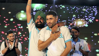 Left to right: Jaspreet Singh from India, second runner-up; Ijaz Khawaja from Pakistan, winner; and Lovepreet Singh from India, first runner-up, celebrate during the award ceremony of the Camp Ka Champ – DU singer of the Season.