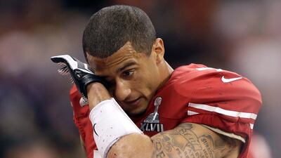 San Francisco 49ers quarterback Colin Kaepernick (7) wipes his face after losing 34-31 to the Baltimore Ravens in the NFL Super Bowl XLVII football game, Sunday, Feb. 3, 2013, in New Orleans. (AP Photo/David Goldman) *** Local Caption *** Super Bowl Football.JPEG-09801.jpg