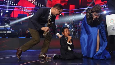 Joshua Oliveros (centre) with coach Lea Salonga (right) on The Voice Kids Philippines. Courtesy ABS-CBN