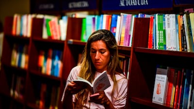 A woman looks at a book in the "El Ateneo Grand Splendid" bookstore. AFP