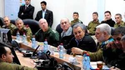 Ehud Olmert, centre left, the Israeli prime minister, and Ehud Barak, centre right, the defence minister, meet military staff officers at the headquarters of the southern command.