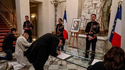 People sign condolence books for late former French president Jacques Chirac at the Elysee presidential palace in Paris on September 26, 2019. AFP
