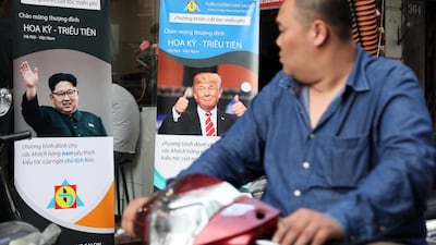 epa07383023 A man rides past posters featuring advertisements for free US President Donald Trump and North Korean leader Kim Jong-un hairstyles outside a salon in Hanoi, Vietnam, 20 February 2019. Le Tuan Duong, the owner of a salon, has offered free Trump or Kim Jong-un hairstyles to any customer, a week before the two leader's second summit which will take place in Hanoi from 27 to 28 February 2019. EPA/LUONG THAI LINH