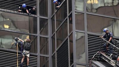 Successful rescues over the years have included window washers dangling 17 stories on the side of a skyscraper, talking down suicide jumpers on Manhattan Bridge and, pictured, a young thrill-seeker who used suction cups to climb the glass walls of Trump Tower. Julie Jacobson / AP Photo / File