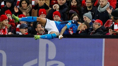 Napoli's Giovanni Di Lorenzo collides with an advertising board at Anfield. Reuters