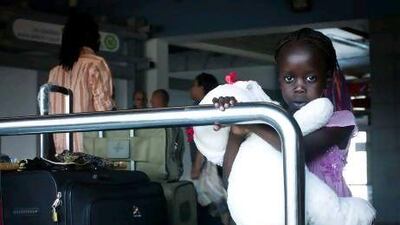 A South Sudanese girl waits with other refugees to board a bus to Ben Gurion International airport, near Tel Aviv, where they were deported to South Sudan yesterday.