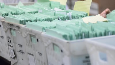 Uncounted provisional ballots sit in boxes at the Schuylkill County Election Bureau in Pottsville, Pennsylvania. The Republican-Herald via AP