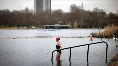 A bather enters the water to swim in the Serpentine Lido in Hyde Park, London. AFP