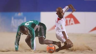 A UAE player, in white, battles for ball control with a Nigeria player back in a tournament at Dubai in November. The UAE recently returned from a tournament in Belarus finishing third. Mike Young for The National