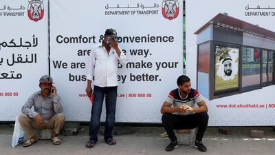 People try to shade from the heat on Sultan bin Zayed the First Street, where a new air-conditioned shelter will be built opposite the Abu Dhabi Bus Terminal. Chris Whiteoak / The National